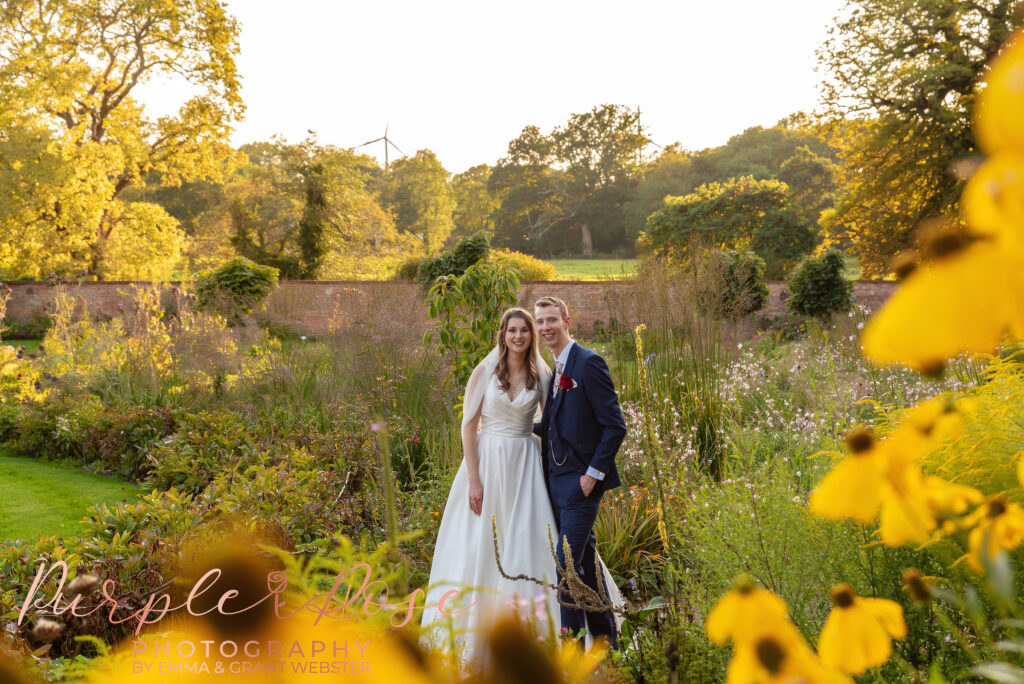 Photo of bride and groom smiling in a garden on their wedding day in Milton Keynes