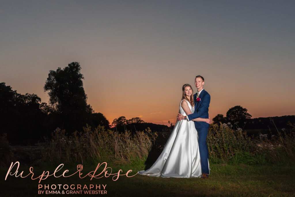 Photo of bride and groom in front of a sunset on their wedding day in Milton Keynes