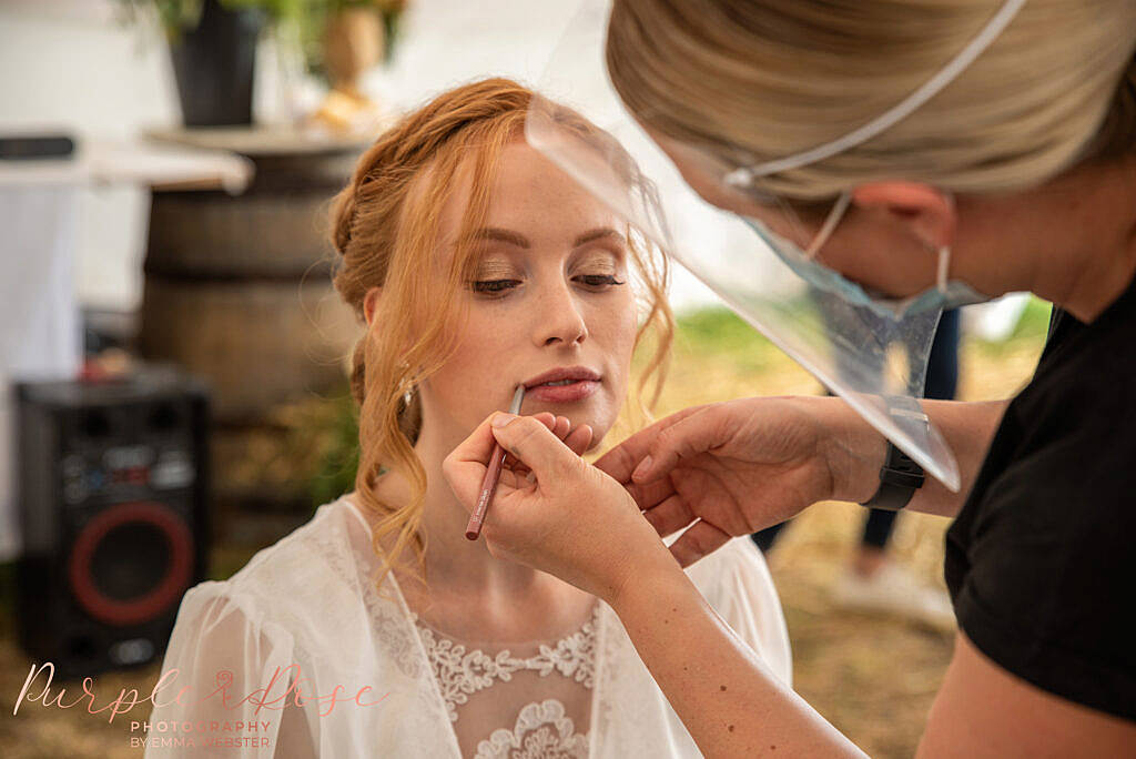 Bride having makeup applied