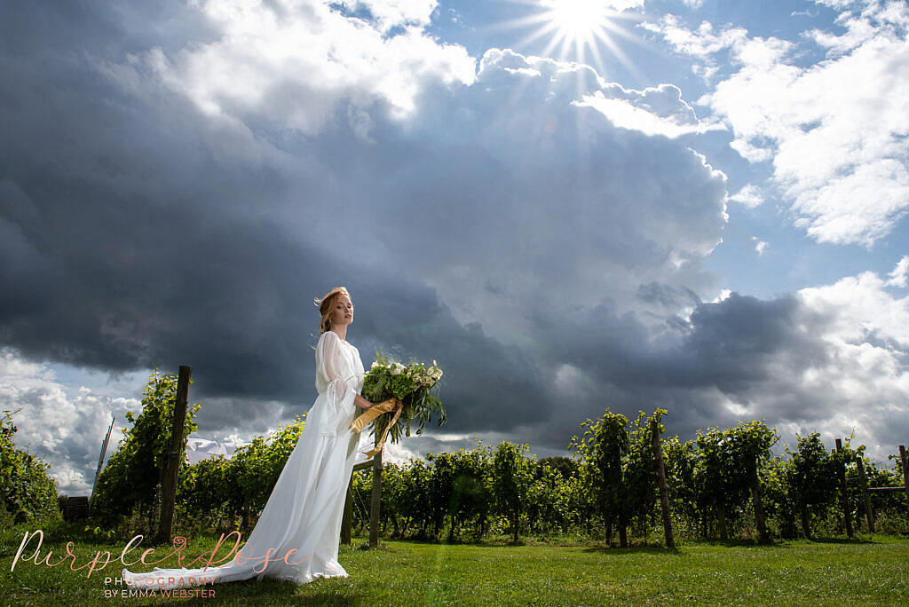 Bride stood in front of a stormy sky