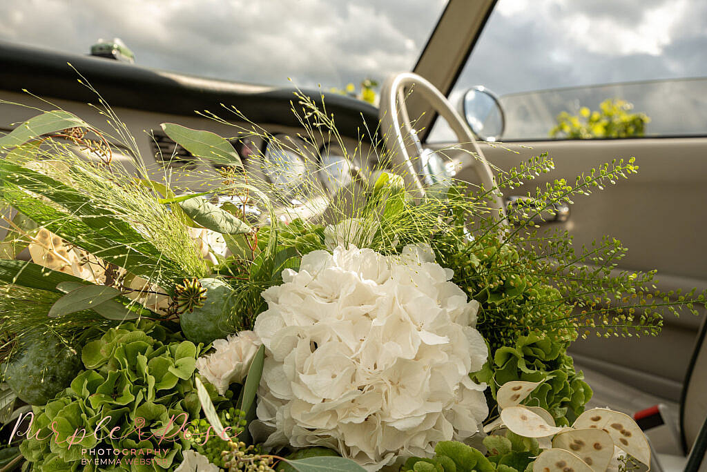 Wedding bouquet in a vintage car