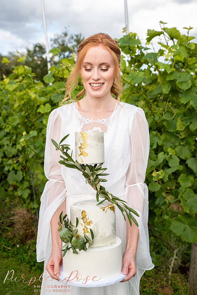 Bride holding her wedding cake