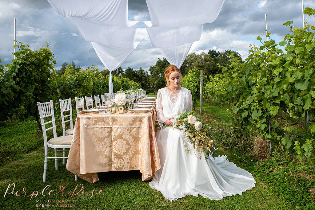 Bride sat holding her bouquet