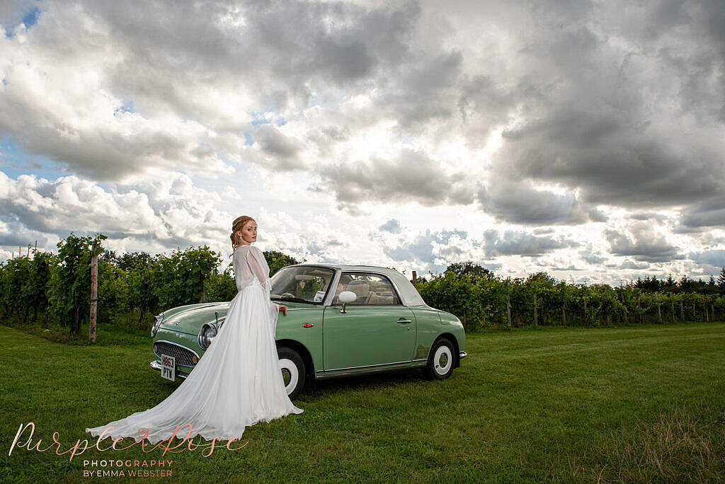 Bride stood by car