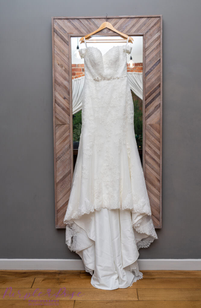 Wedding dress hanging on a mirror frame