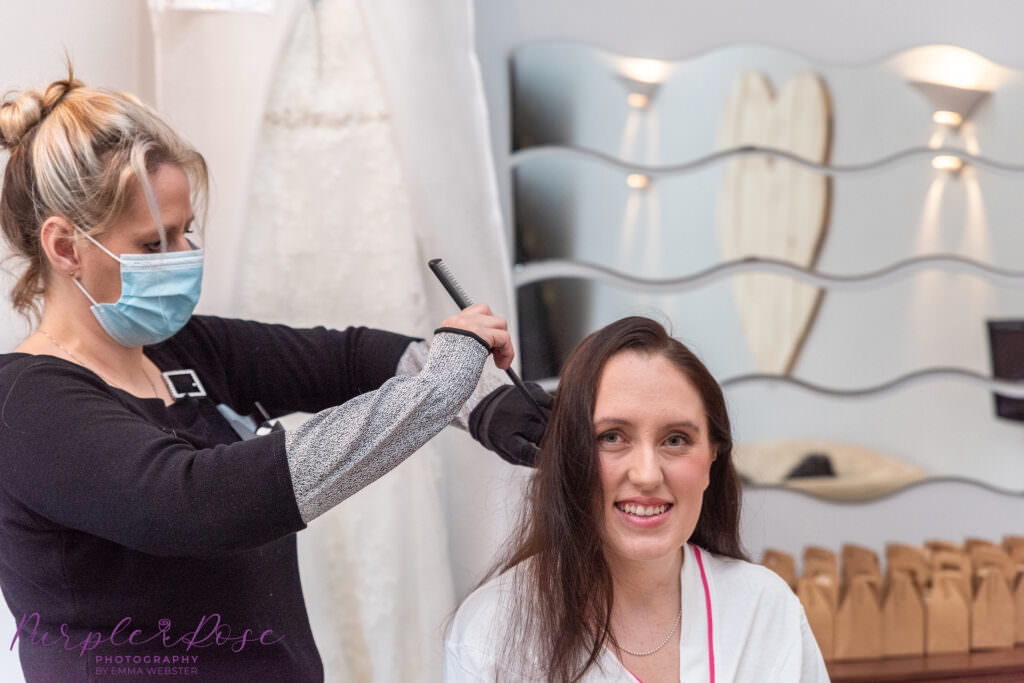 Bride having her hair styled