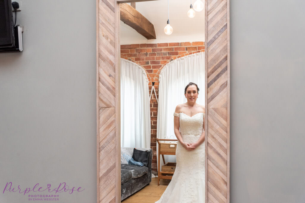 Bride checking her reflection in a mirror