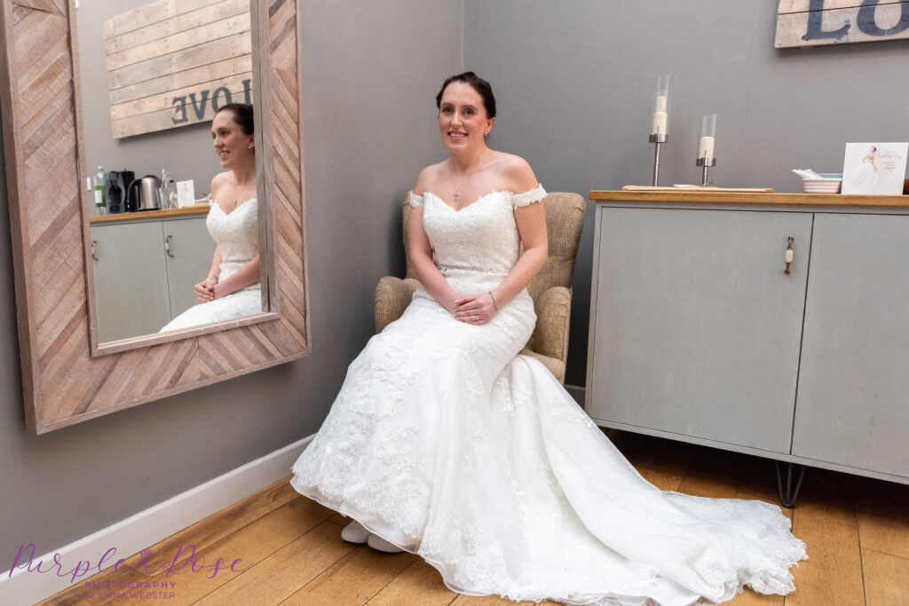 Bride sat in a chair by a mirror