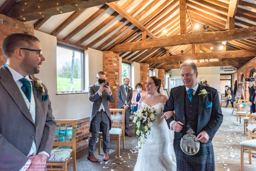 Bride walking with her father into the wedding ceremony