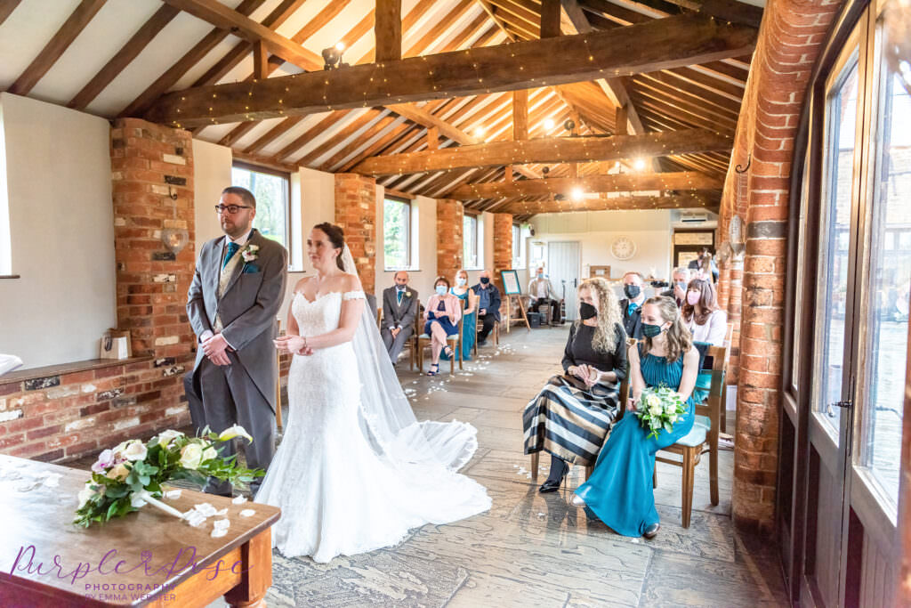 Couple during their wedding ceremony with guests watching