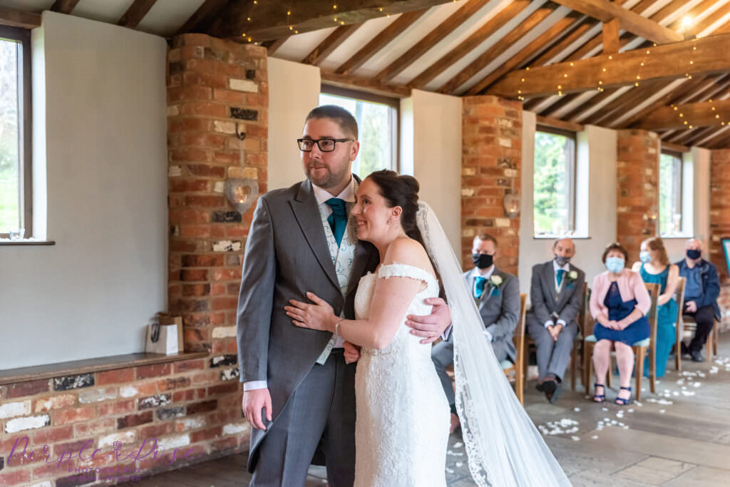 Bride and groom hugging during wedding ceremony