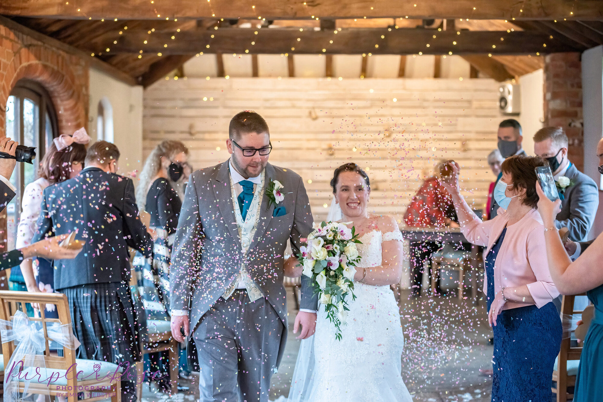 Bride and groom having confetti throne over them