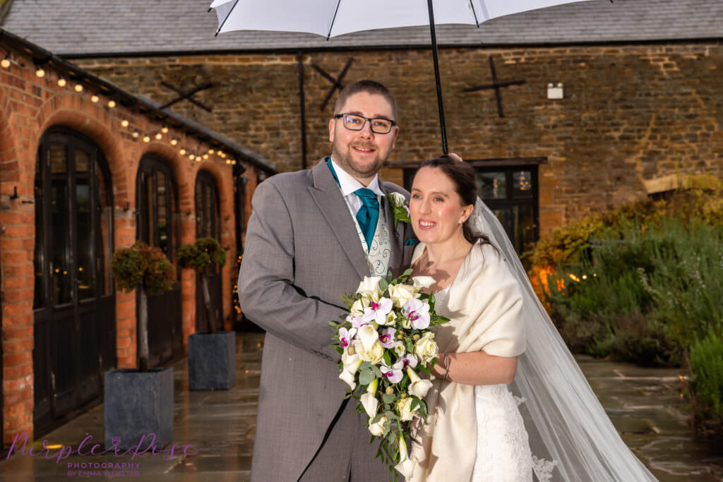 Bride and groom on a rainy wedding day