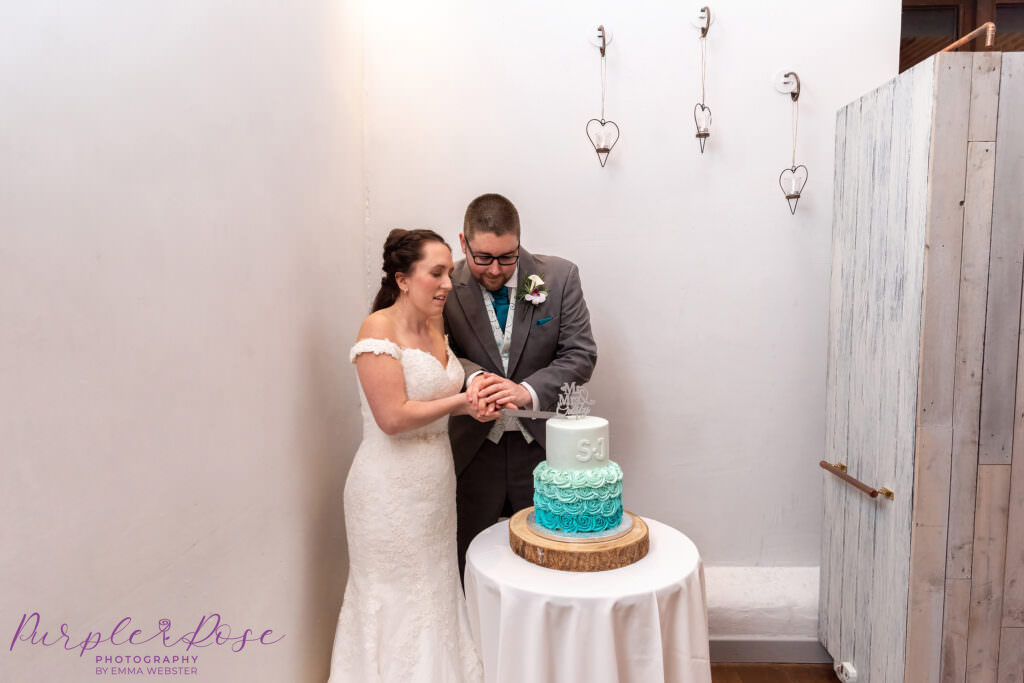 Bride and groom cutting their wedding cake