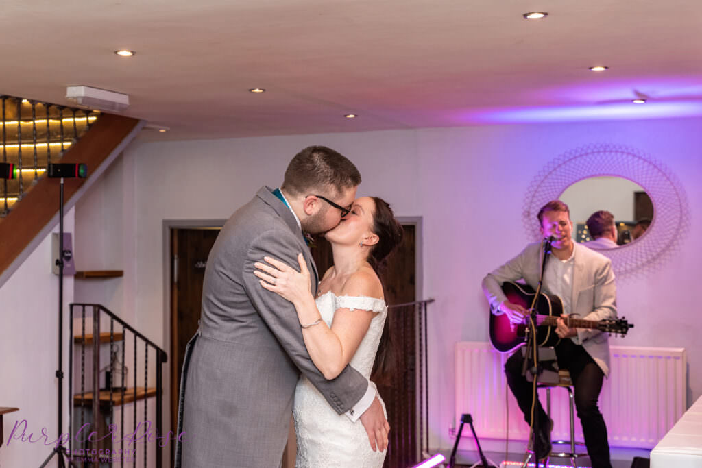 Bride and groom kissing during their 1st dance