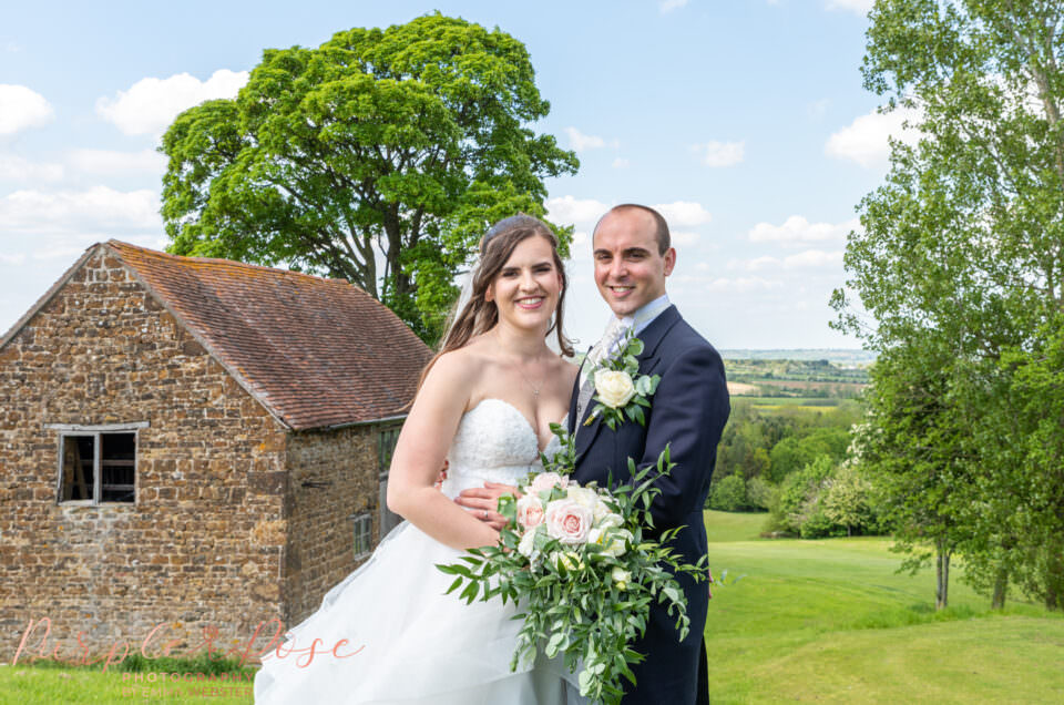 Couple by a barn at Hellidon lakes