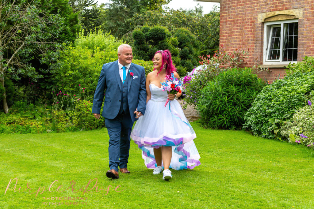 Bride walking through garden with her father