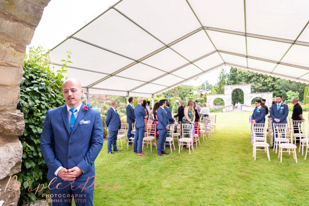 Groom under a canopy waiting for his bride to arrive