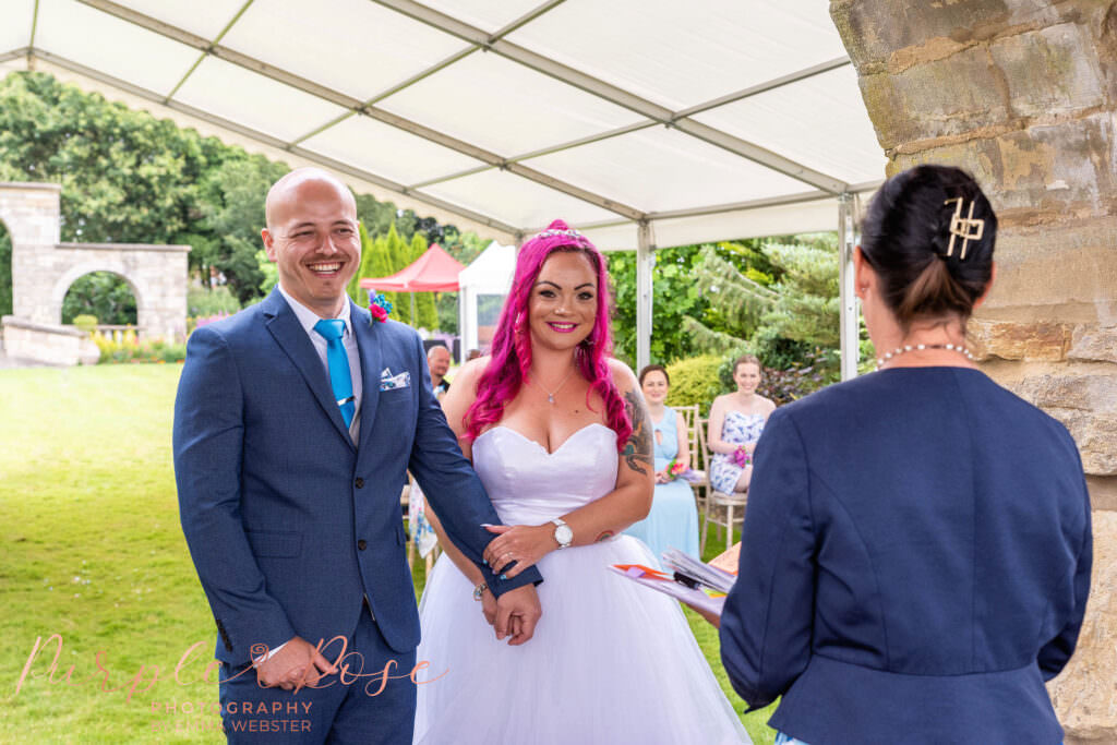 bride and groom laughing during their wedding ceremony