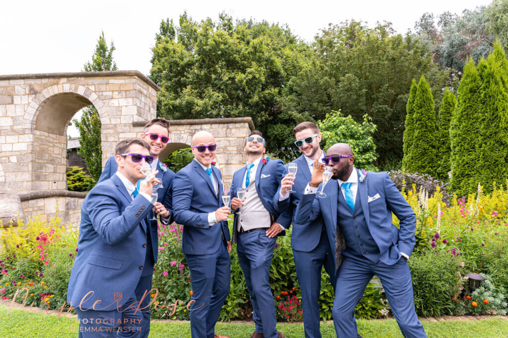 Groomsment wearing sun glasses and enjoying a drink