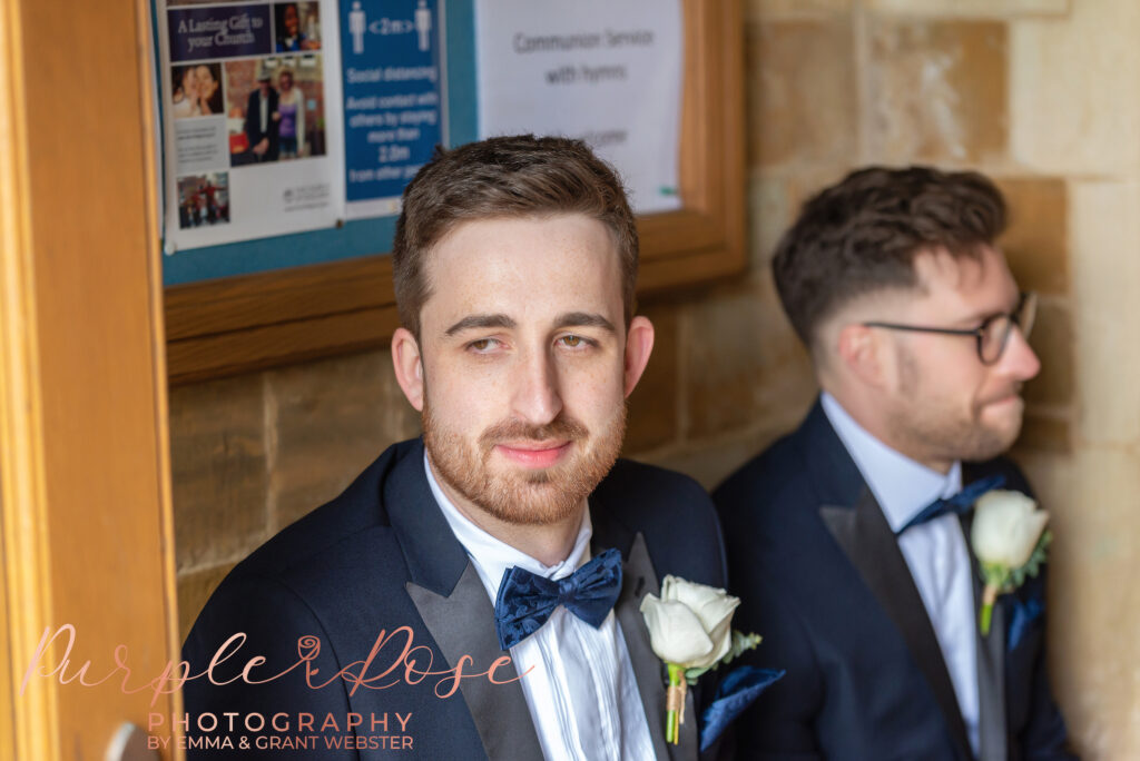 Photo og groom sat at the church before his wedding ceremony in Milton Keynes