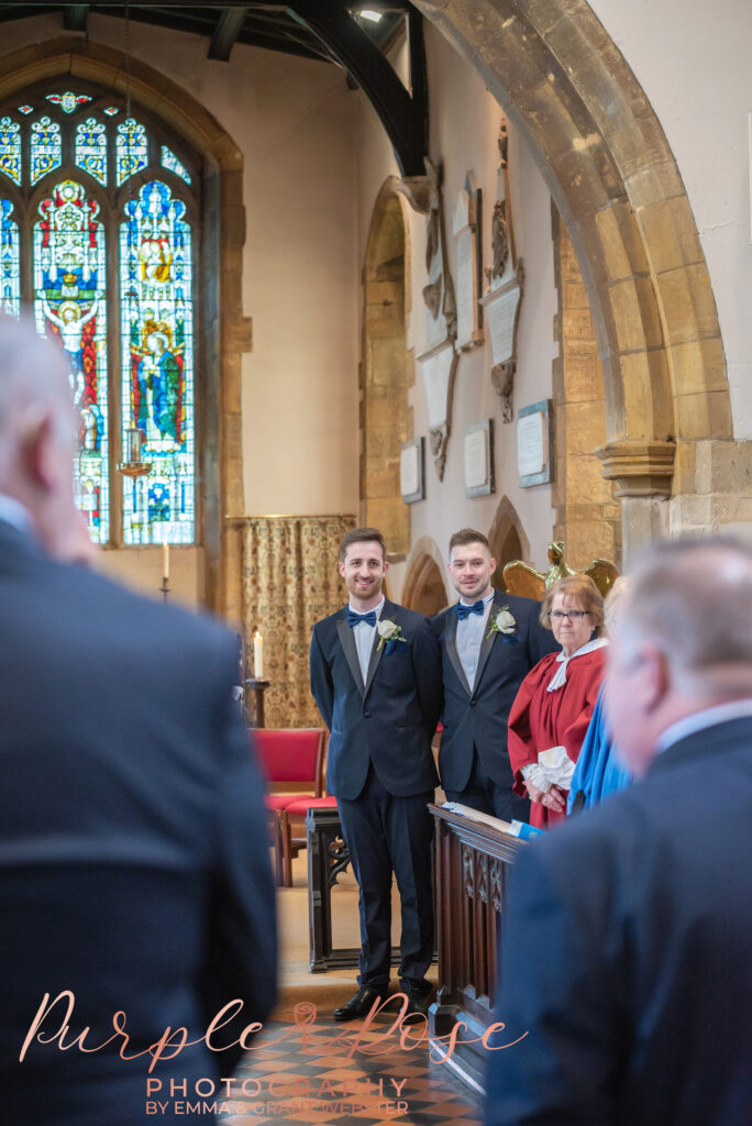 Photo of groom stood in a church in Milton Keynes waiting for his bride to arrive.
