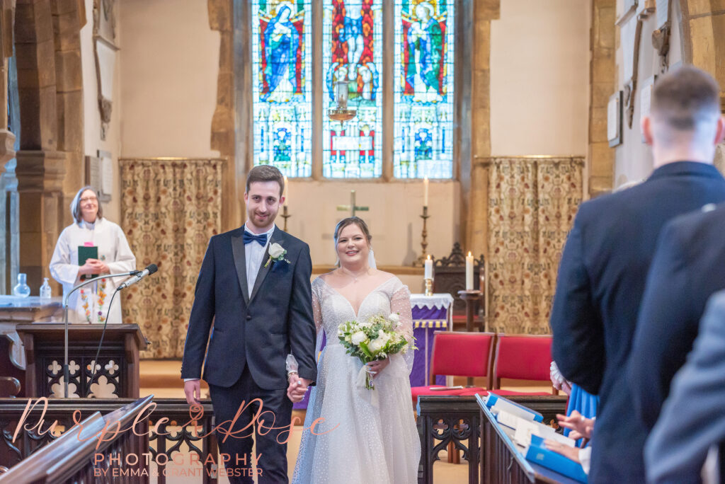 Photo of bride and groom leaving the church on their wedding day in Milton Keynes