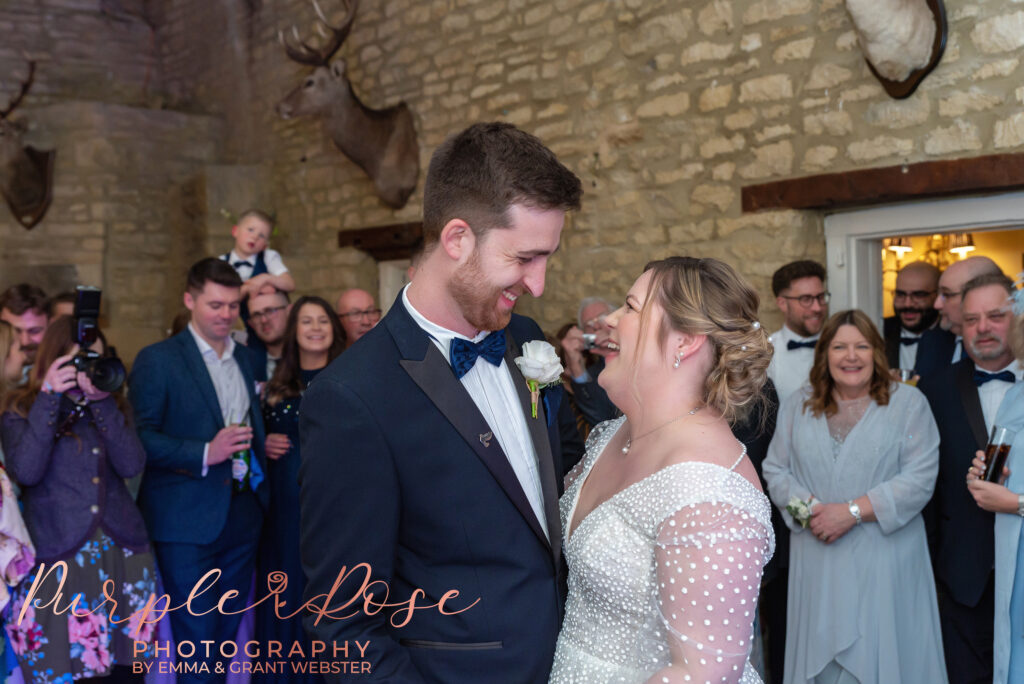 Photo fo bride and groom smiling together as they dance on their wedding day in Milton Keynes