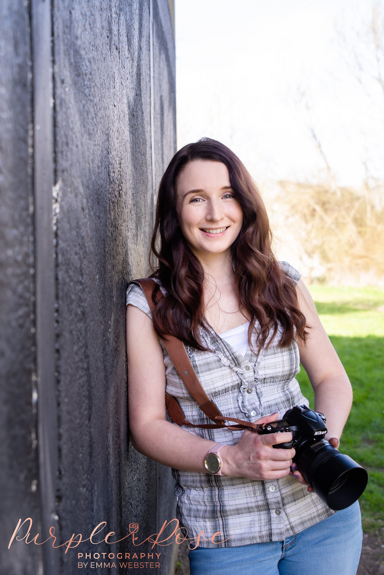 Photographer leaning holding their camera