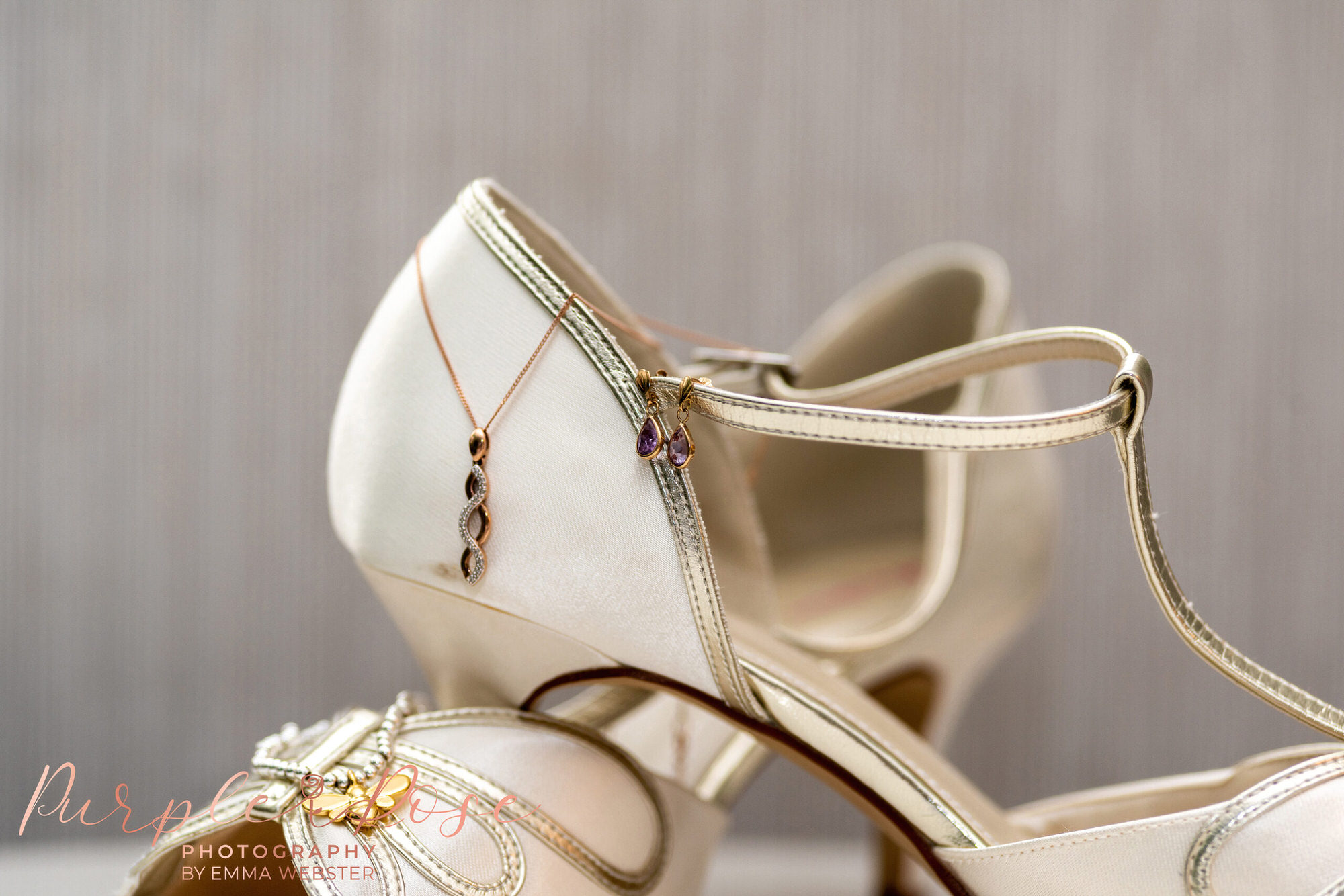 Brides jewellery draped over her shoes