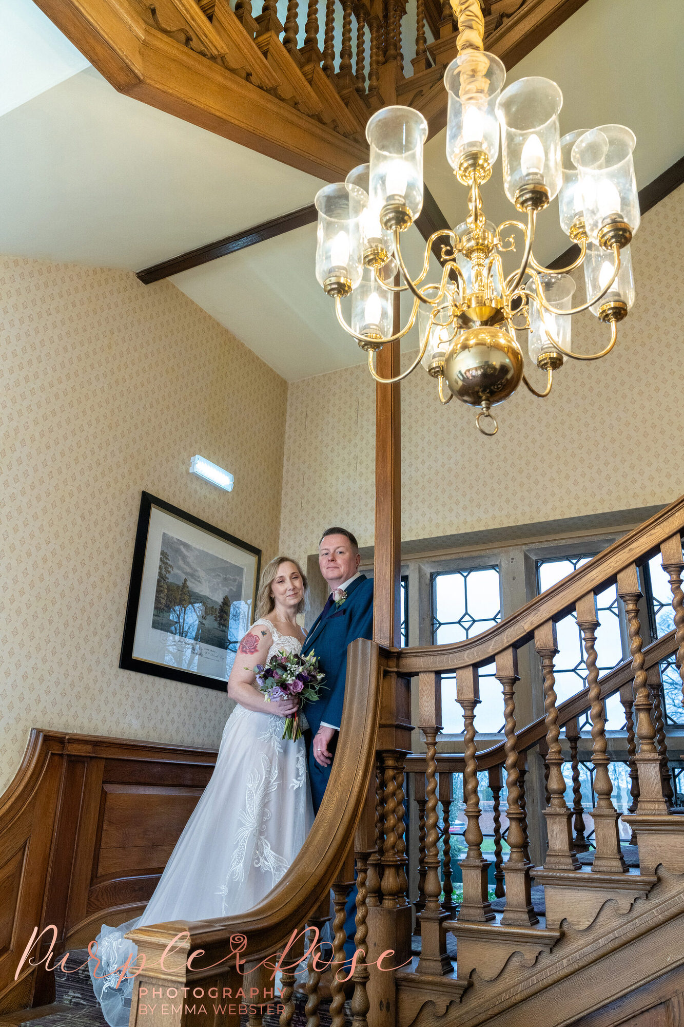 Bride and groom stood on winding staircase