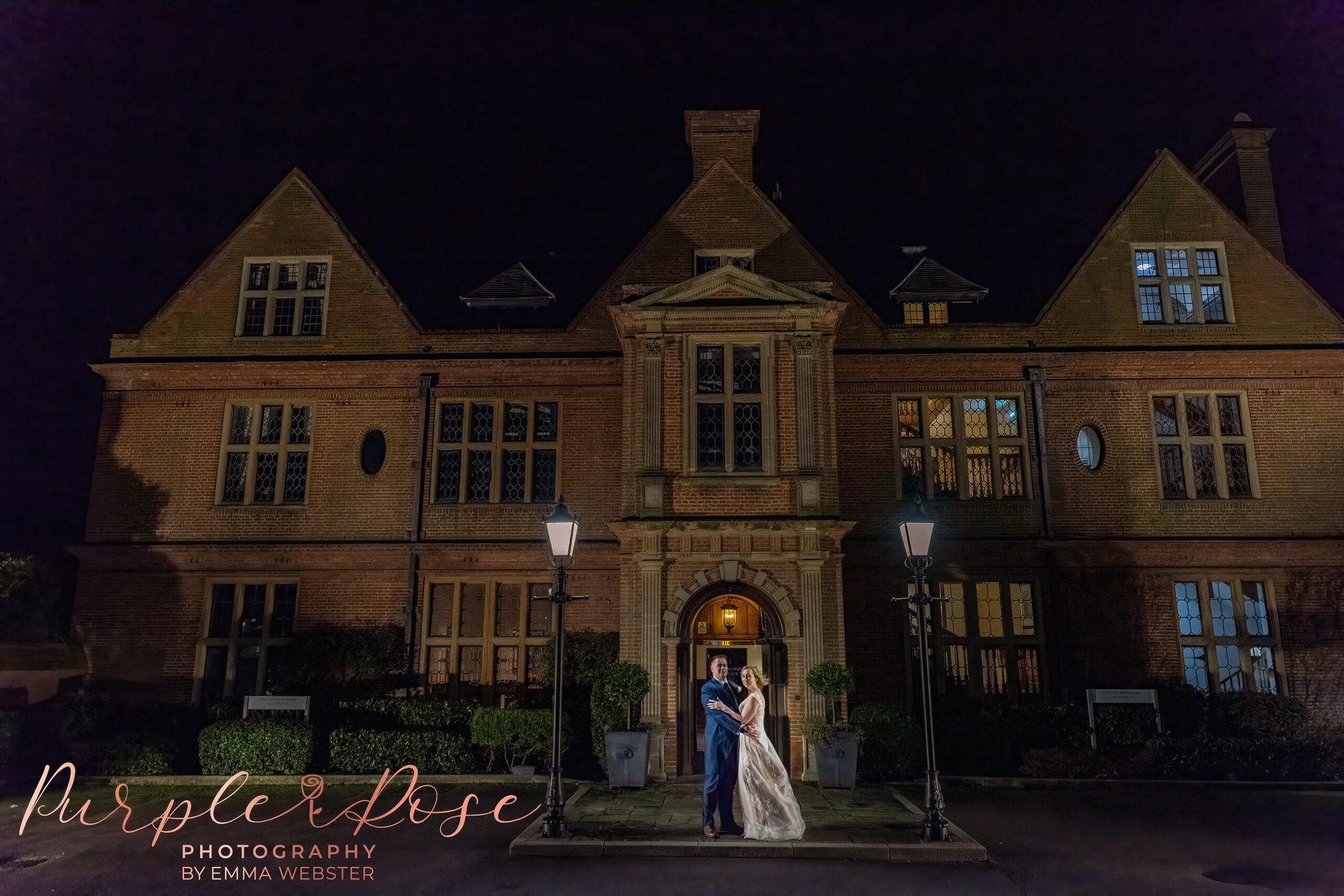 bride and groom at night by their wedding venue