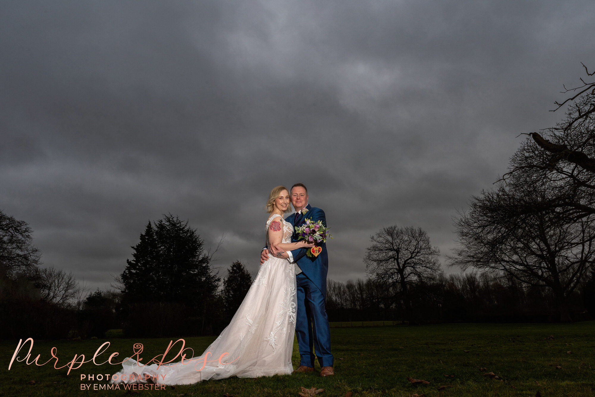 Bride and groom in front of a stormy sky
