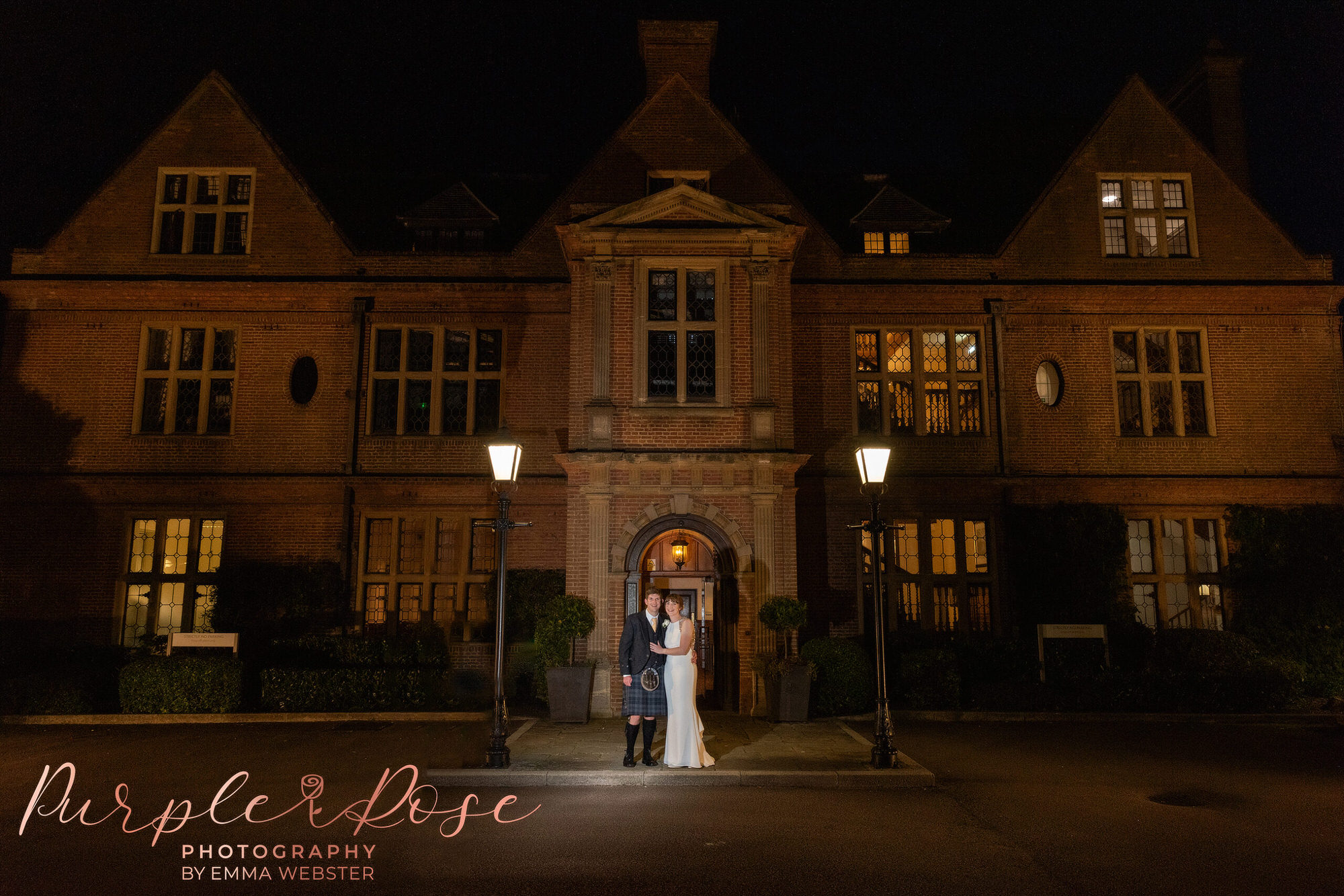 Bride and groom in front of Horwood House at night