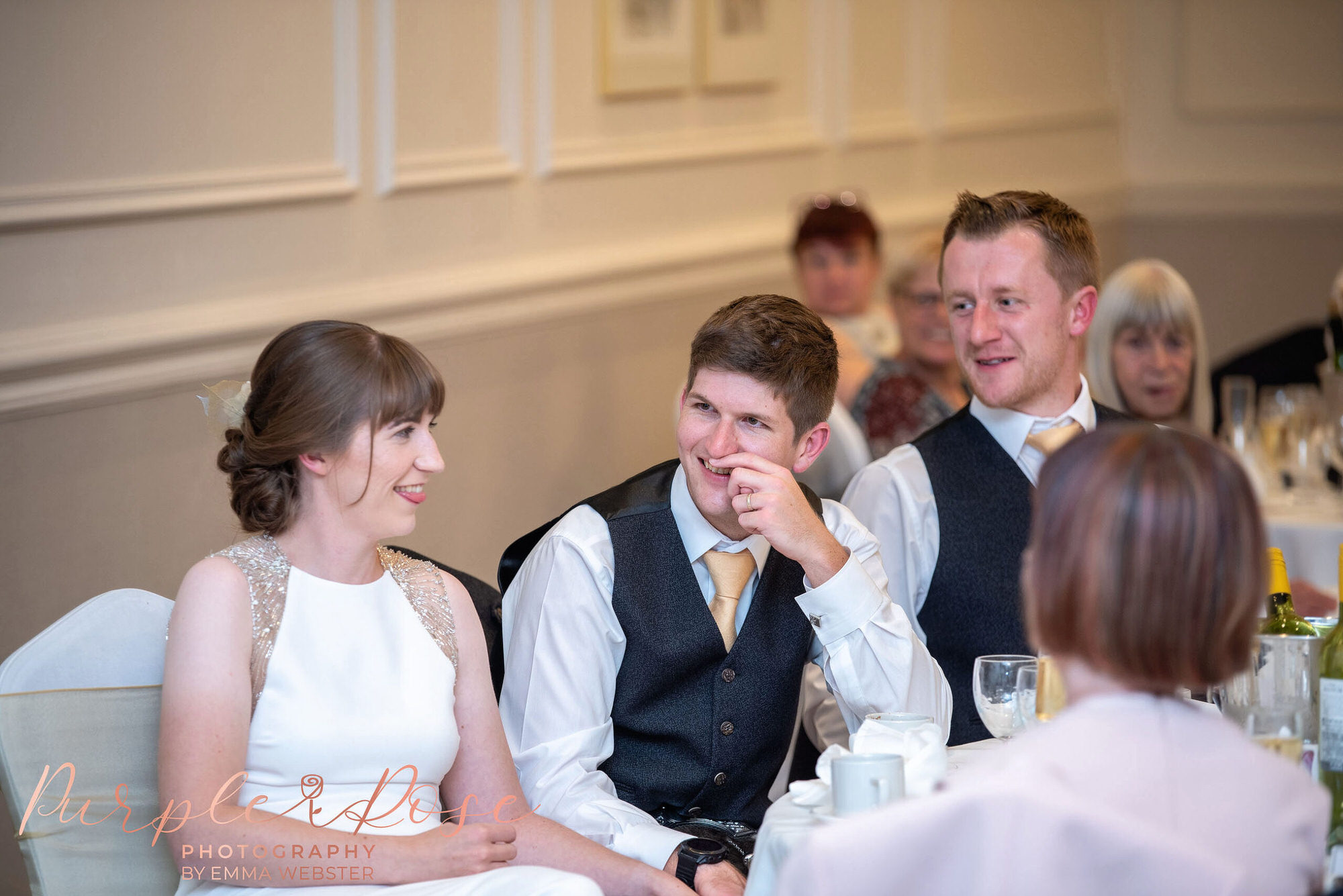 Groom laughing during speeches