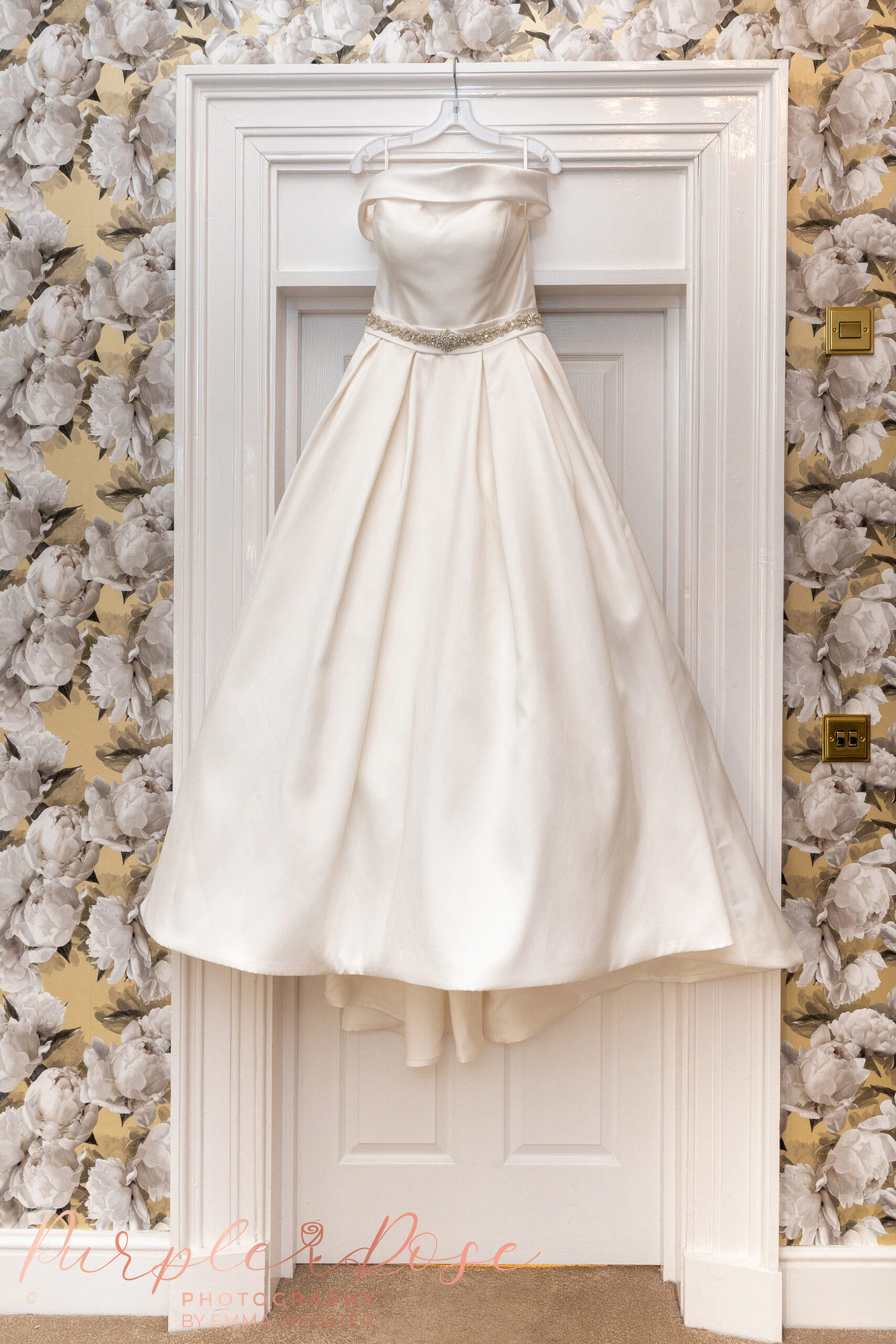 Wedding dress hanging on a door frame