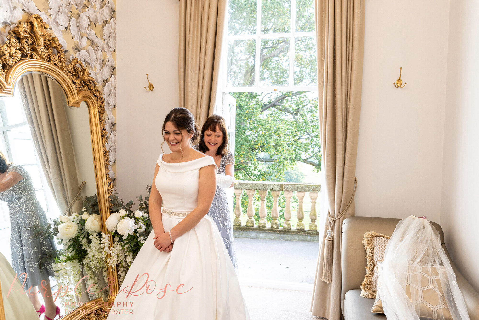 Brides mum helping her get dressed