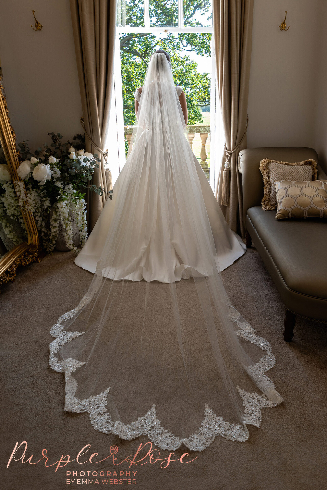 Back of a bride wearing a cathedral veil