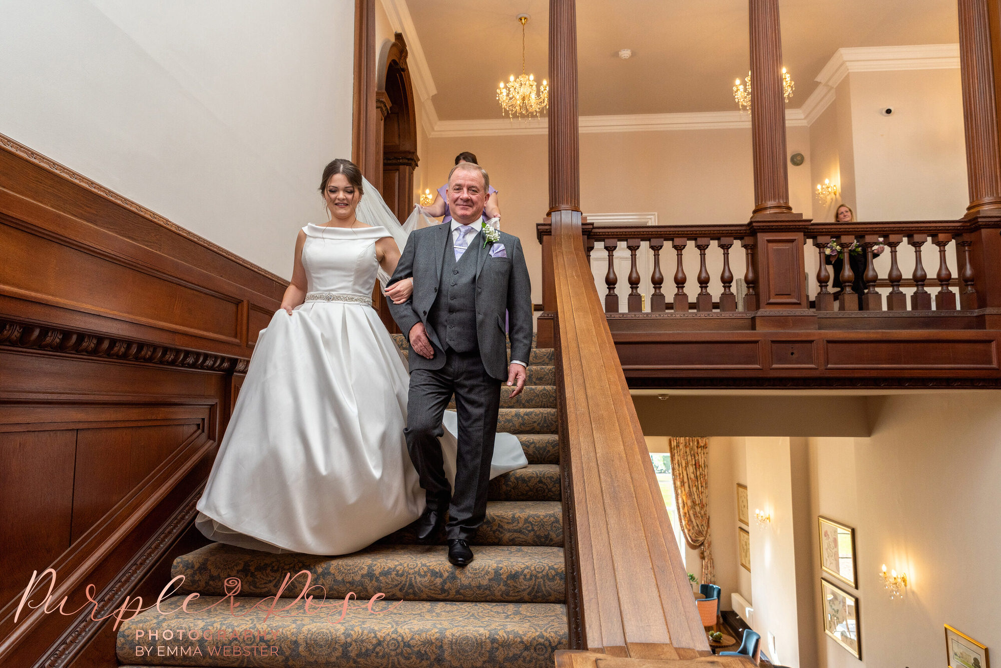 Father and bride walking down a staircase