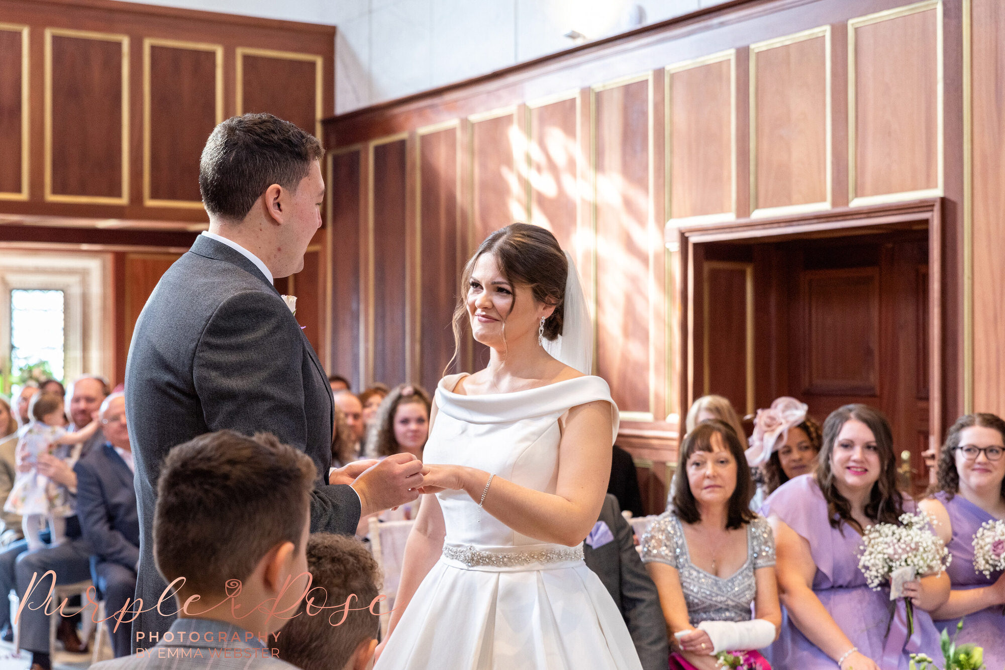 Bride and groom exchanging wedding rings