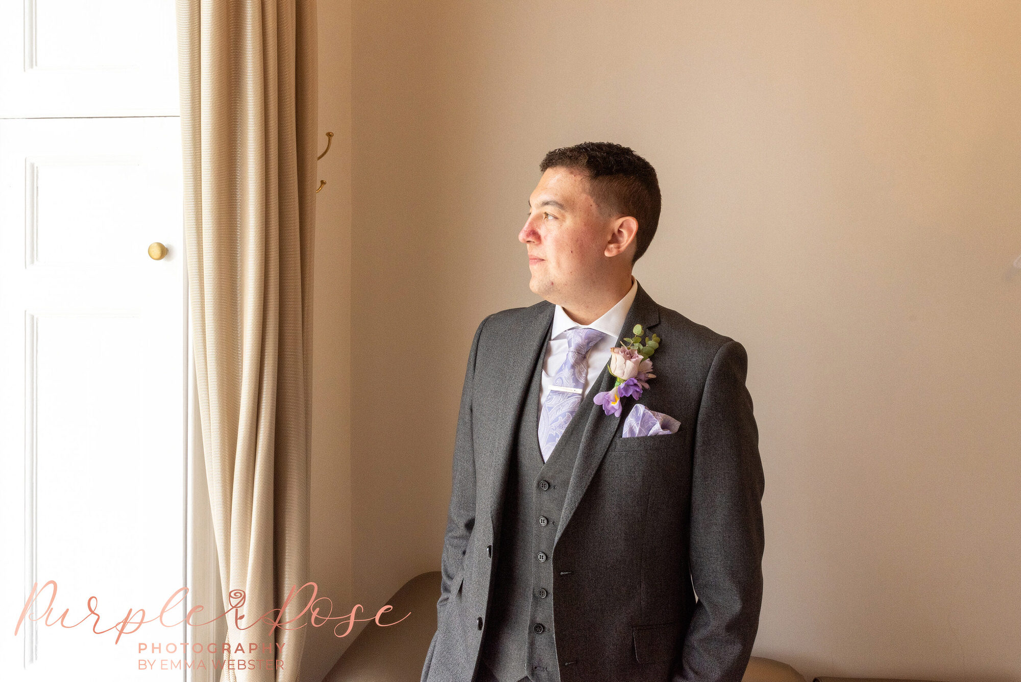 Groom looking out a window