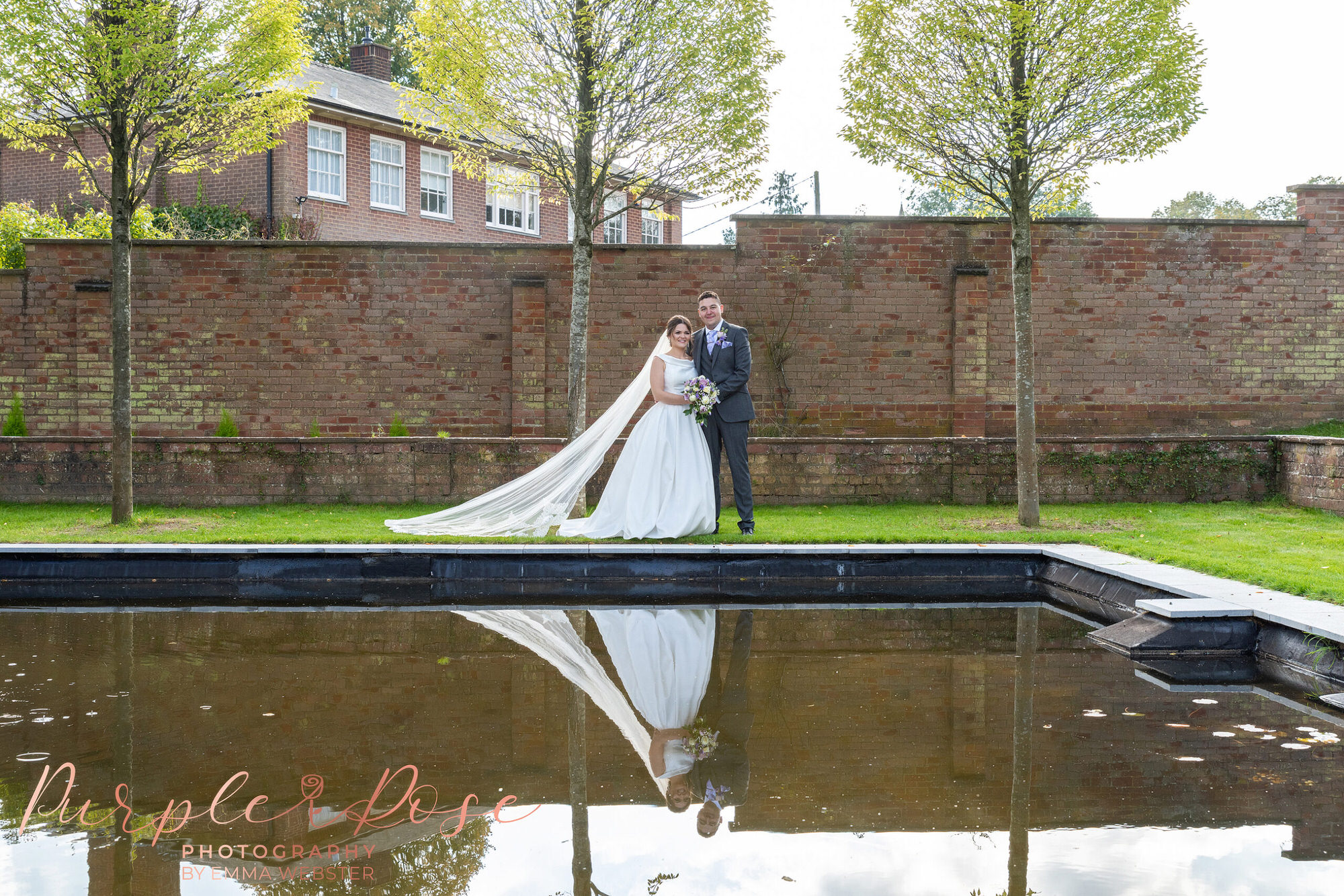 Bride and groom by a pond