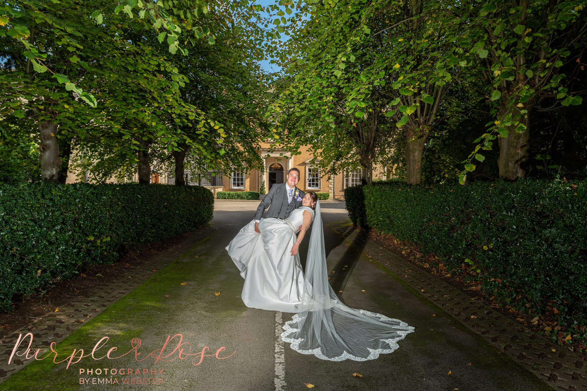 Bride and groom in front of their wedding venue