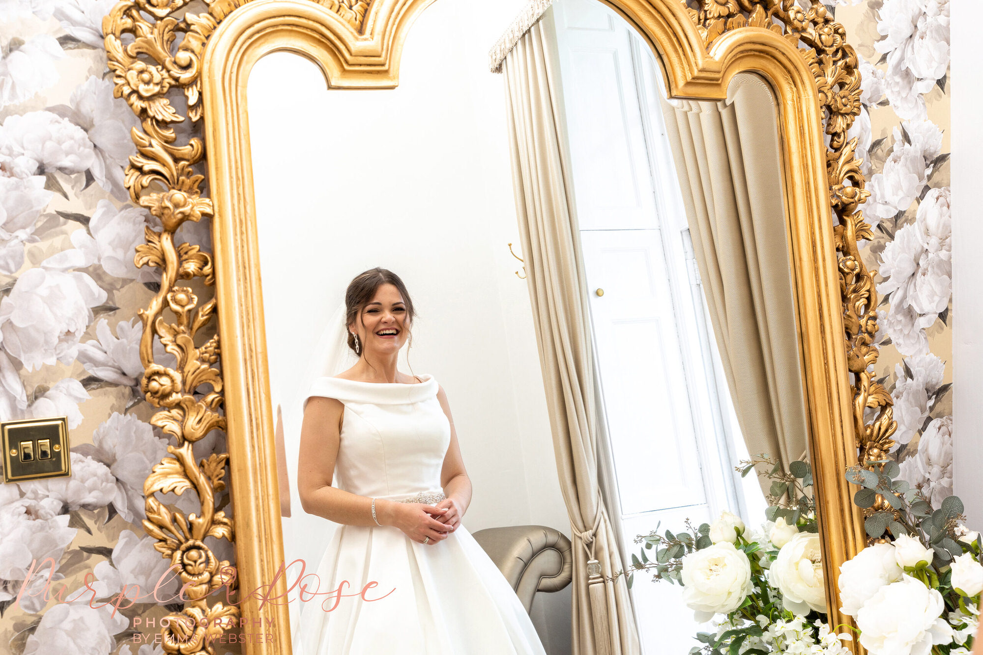 Bride looking at her reflection in a mirror