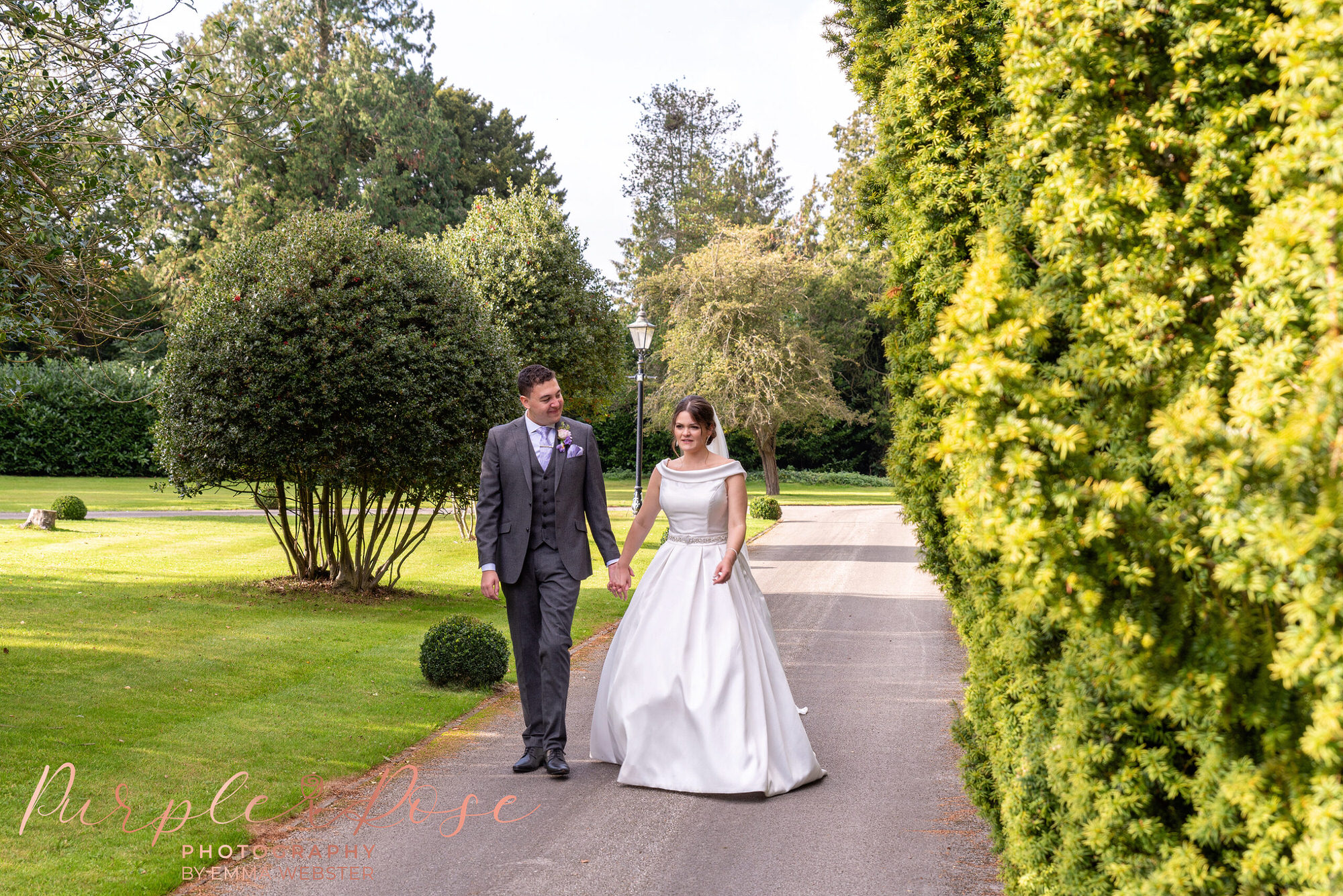 Bride and groom walking along a pathway