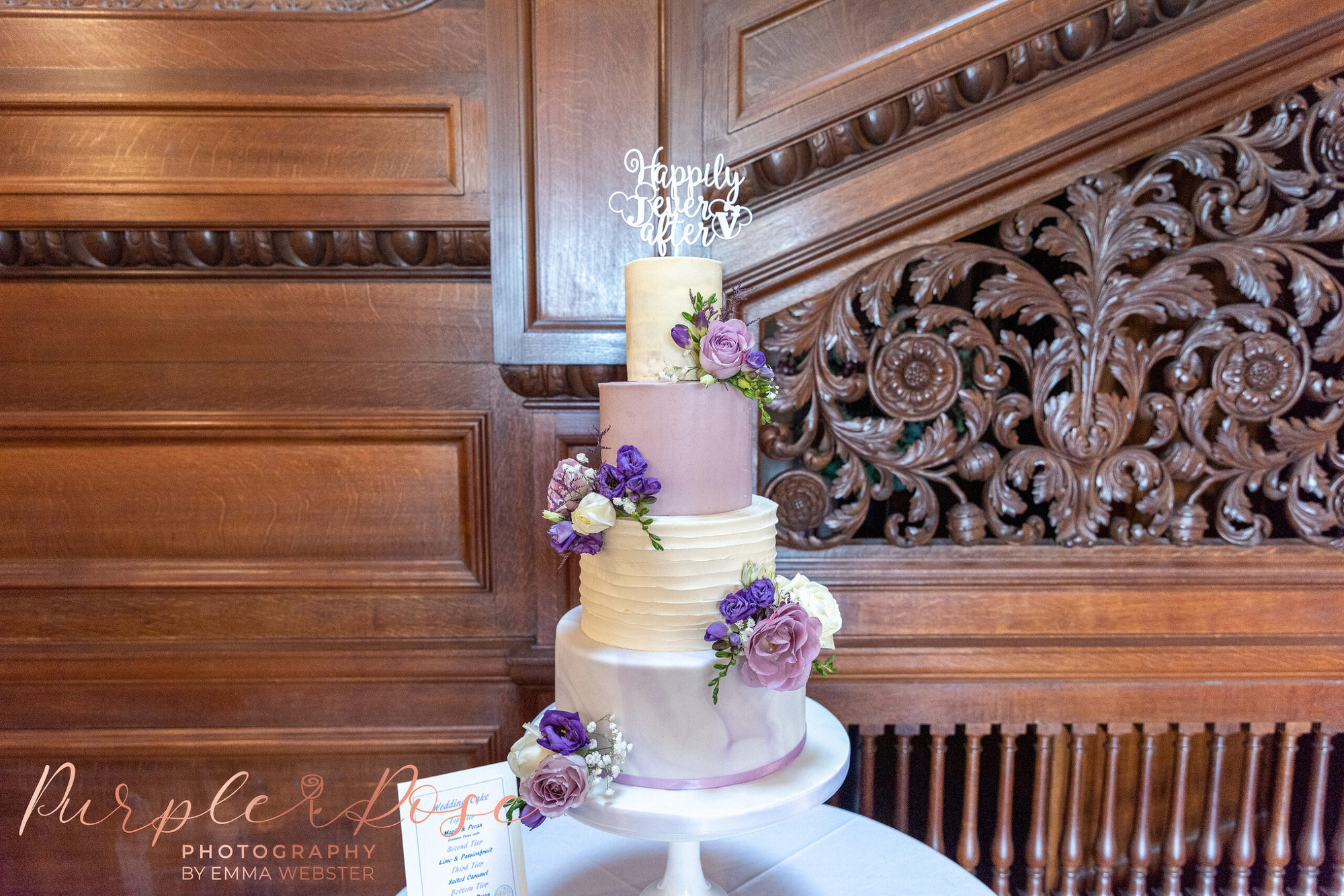 Purple and white wedding cake decorated with flowers