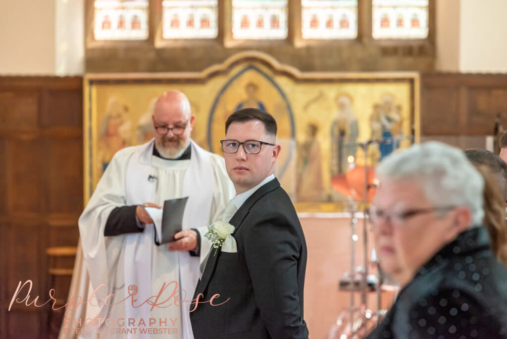 Groom looking for his bride as the wedding ceremony starts