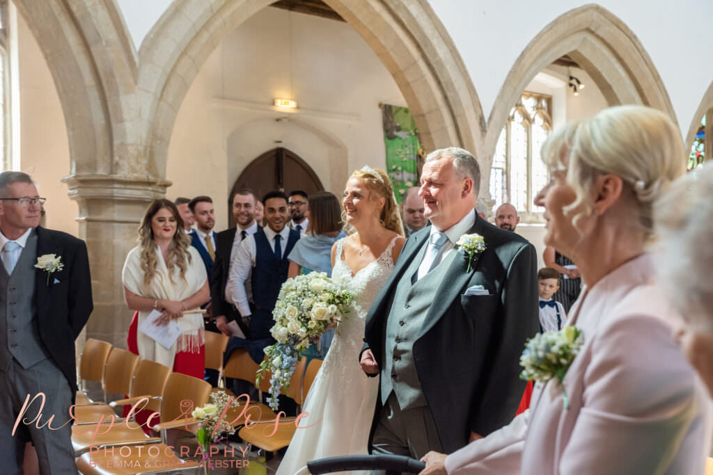 Bride walking with her father in the church