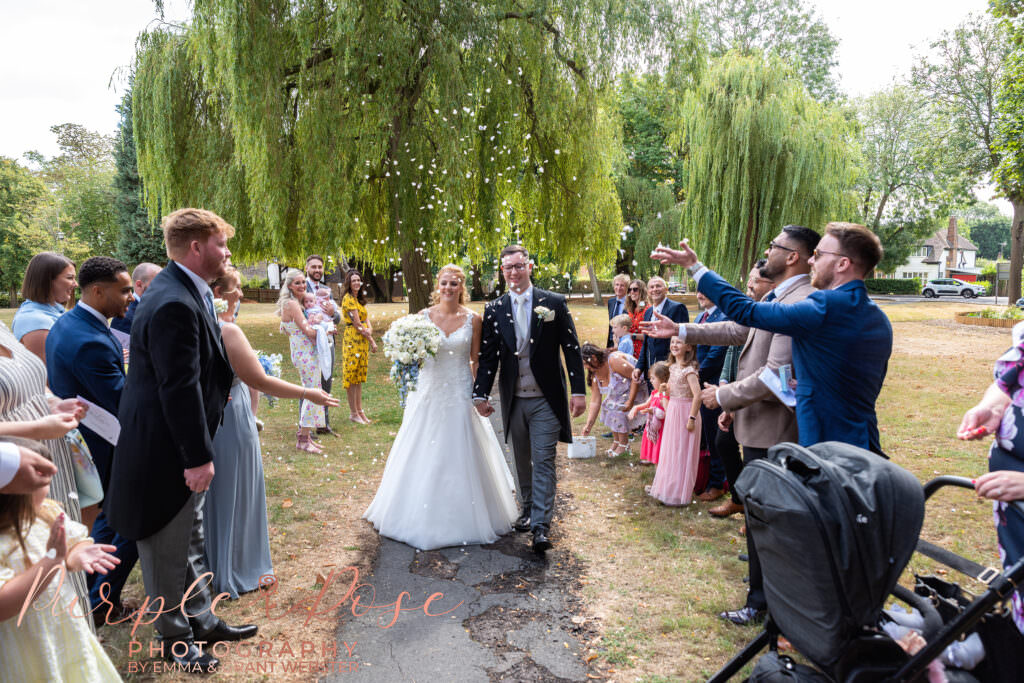 Bride and grooms guest throwing confetti