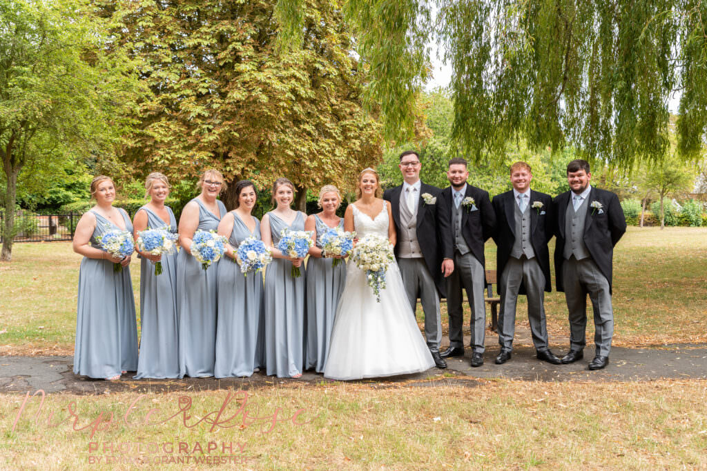 Wedding party stood together for a group photo